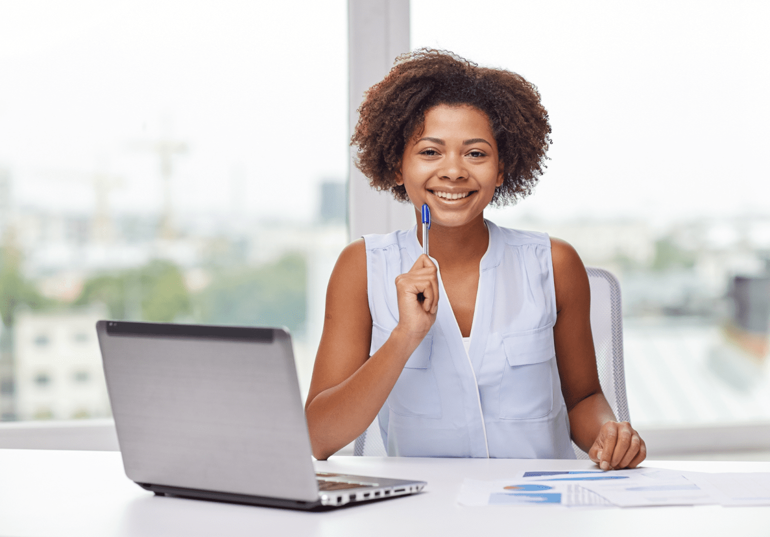 A woman sitting at a table with a laptop.