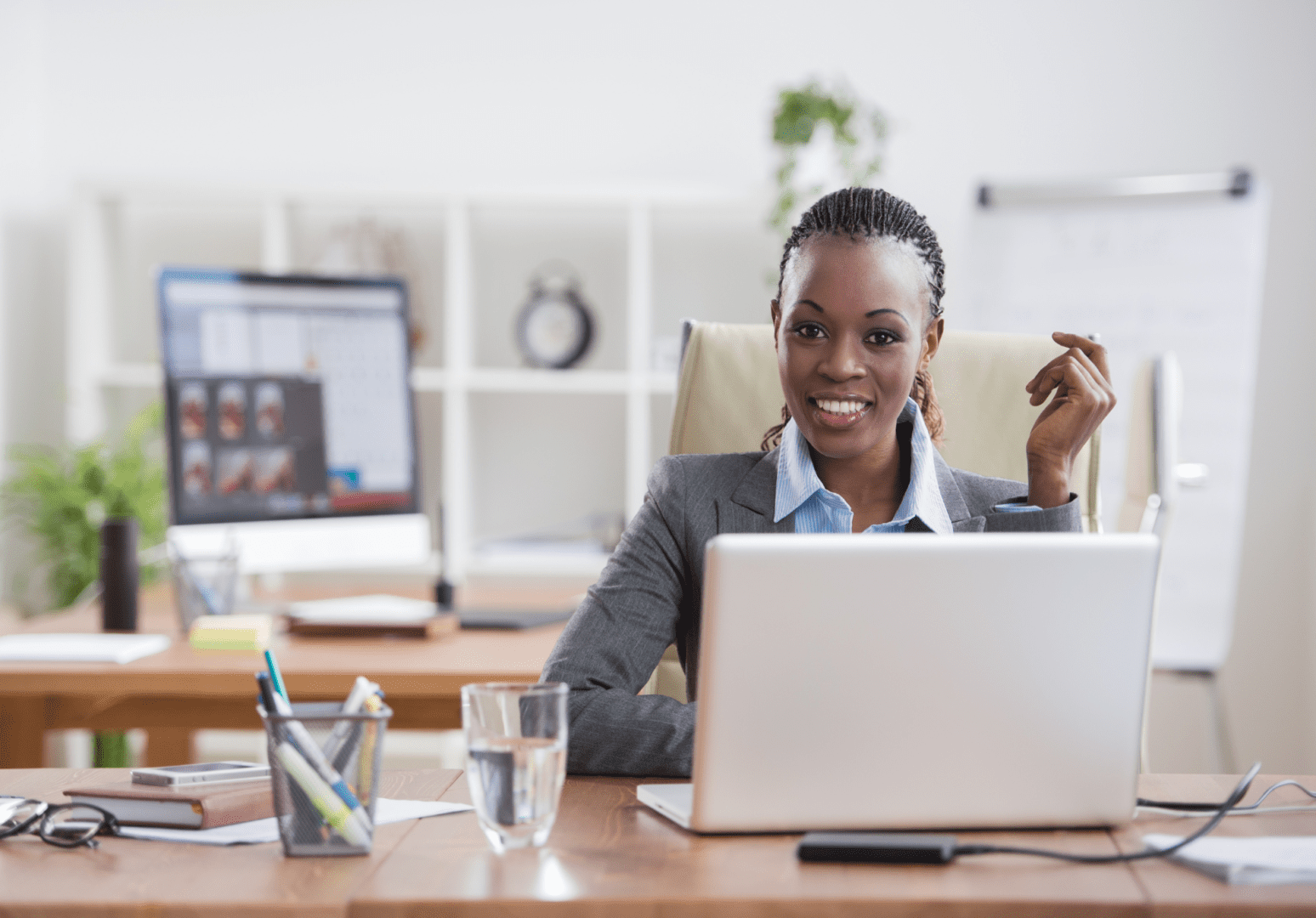 A woman sitting at her desk with a laptop.